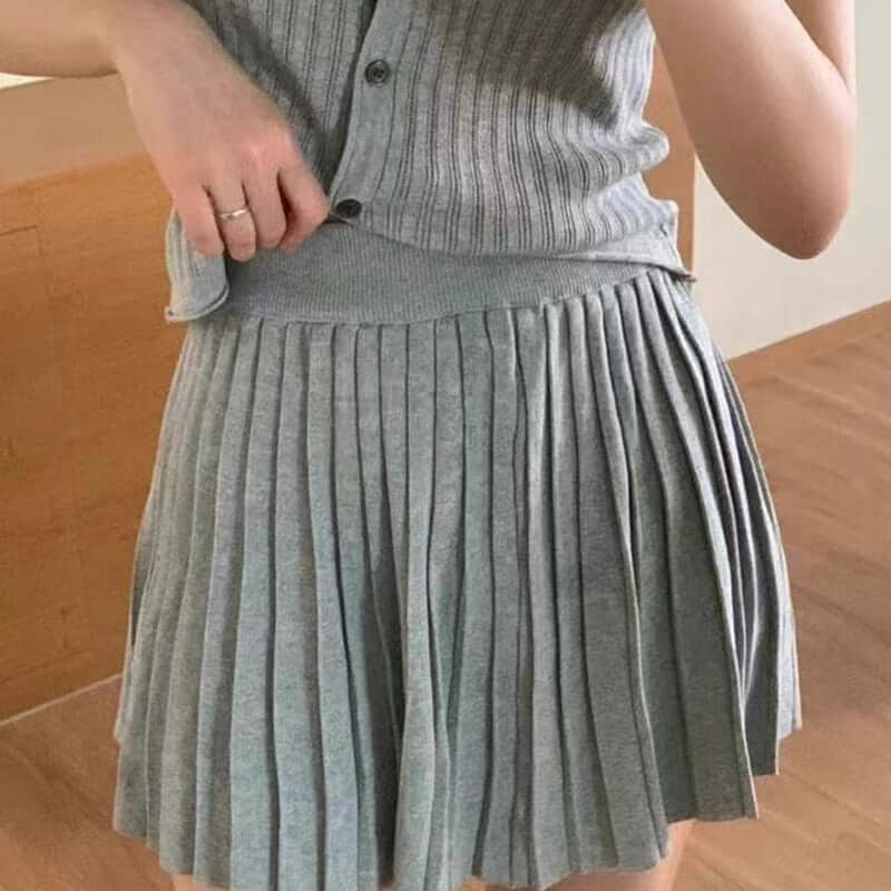 Light grey pleated dress featuring a stylish ribbed top and a flattering silhouette, perfect for casual and chic occasions.