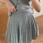 Light grey pleated dress featuring a stylish ribbed top and a flattering silhouette, perfect for casual and chic occasions.